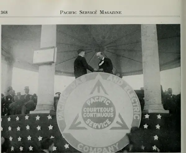 President Frank G. Drum (R) receiving the bronze plaque at the hands of President Charles C. Moore (L)
